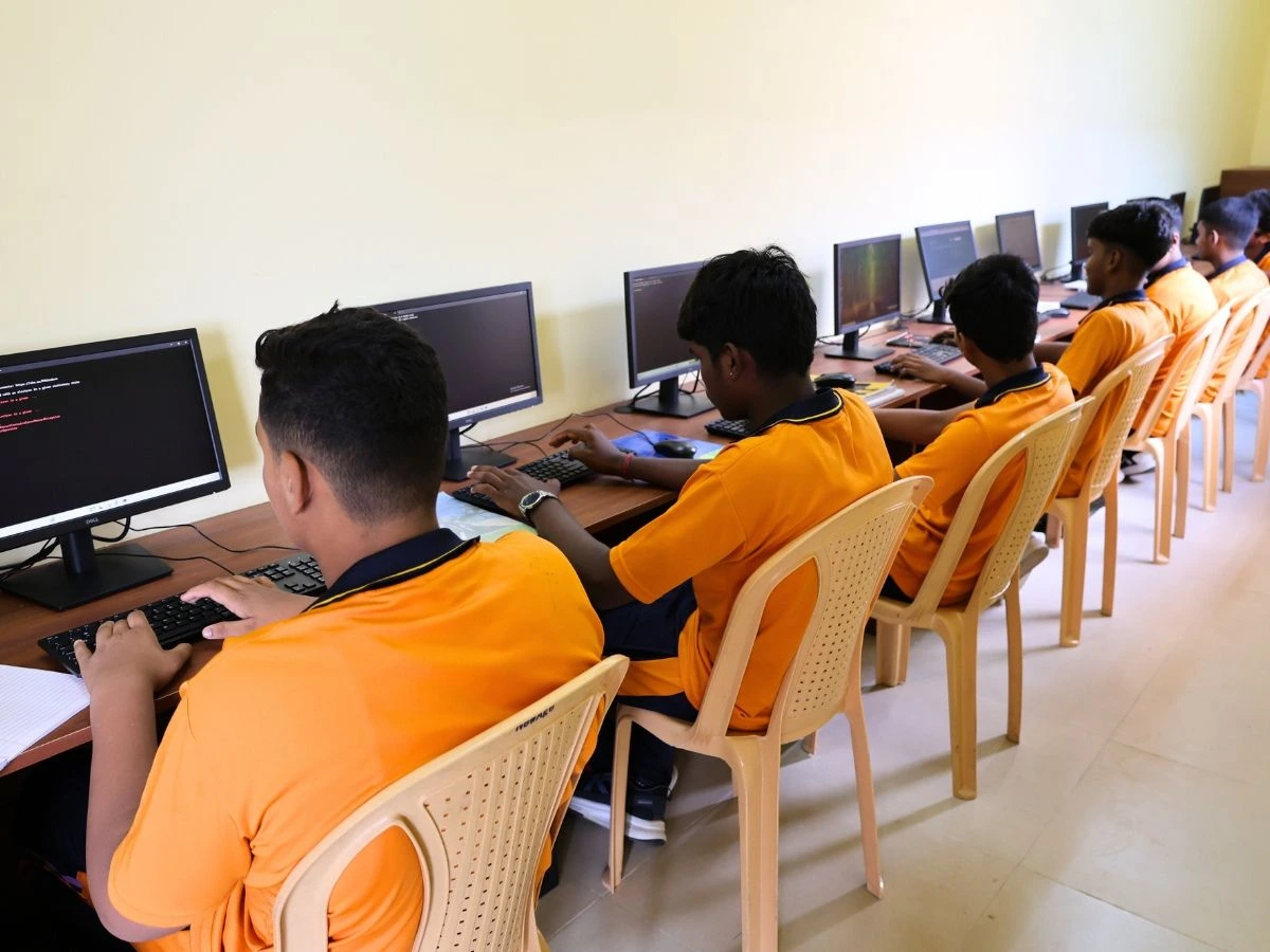 Students using laptops in the computer lab at NewAge PU College