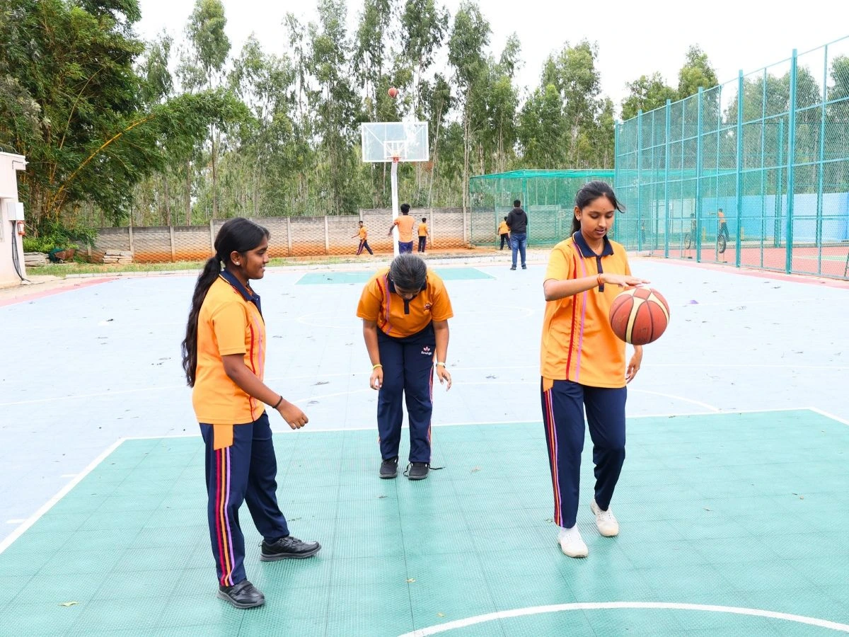 Students relaxing on the green campus grounds at NewAge PU College